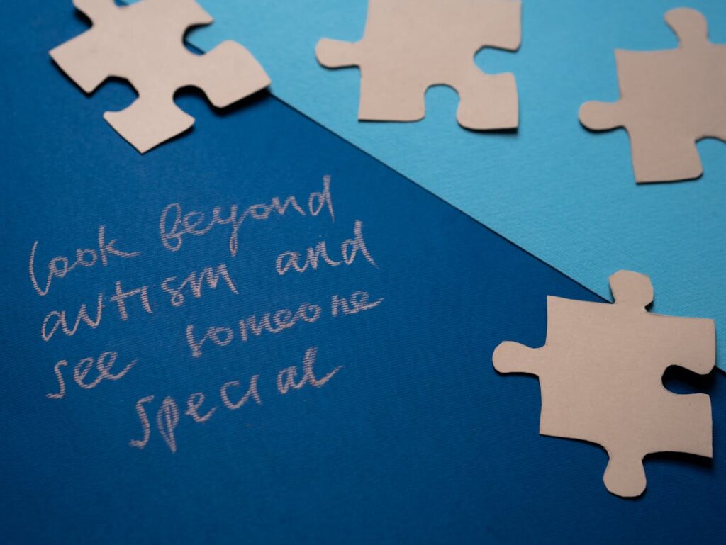 Inspirational autism awareness message with puzzle pieces on blue background.